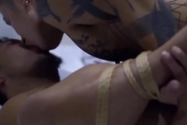 Yoshi Kawasaki, a tattooed stud, dominates a bound Asian guy, rimming his ass and penetrating him raw. The Asian lad endures intense bareback action, showcasing Yoshi's expertise in extreme gay sex.