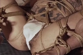 Yoshikawasaki, a hunky Asian jock, is bound and blindfolded, his piercings glistening under dim light. His body, adorned with intricate tattoos, writhes in anticipation of a hard spanking. This hardcore fetish video is a tantalizing display of Asian bondage.
