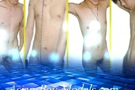 Muscular Asian teen boasts a massive cock, eagerly stroking it for the camera in a tantalizing display of self-pleasure. His chiseled physique and impressive endowment make for an irresistible gay bigcock encounter.