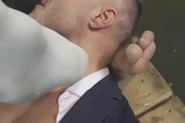 Businessman licks car mechanics feet while teasing big dick